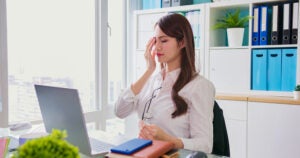 Tired woman taking off glasses is feeling eye strain