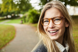 Smiling glasses girl in park