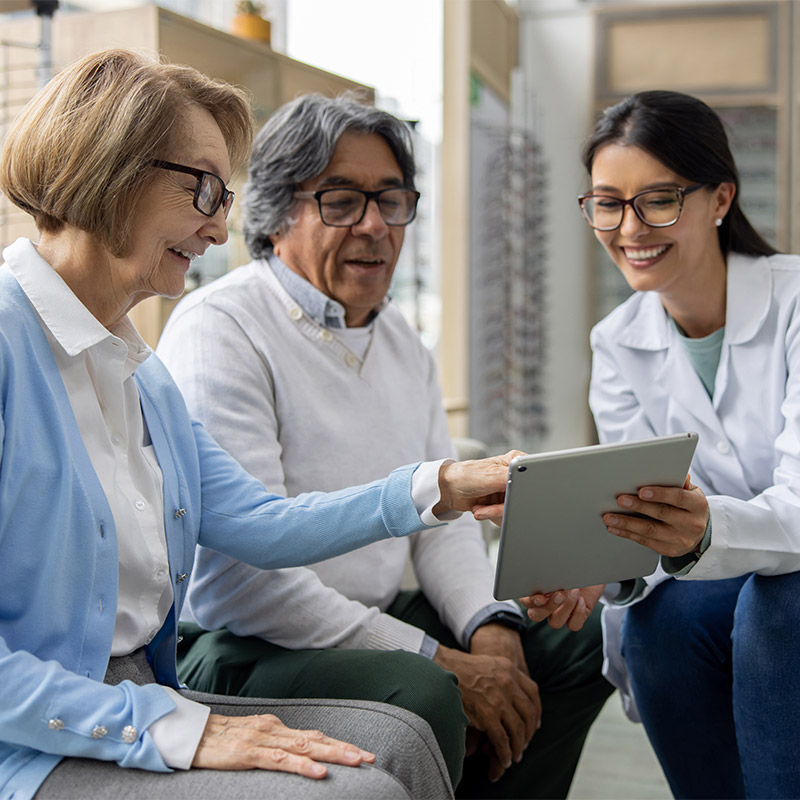 optometrist talking with older couple