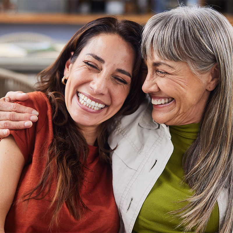 two women smiling and laughing together