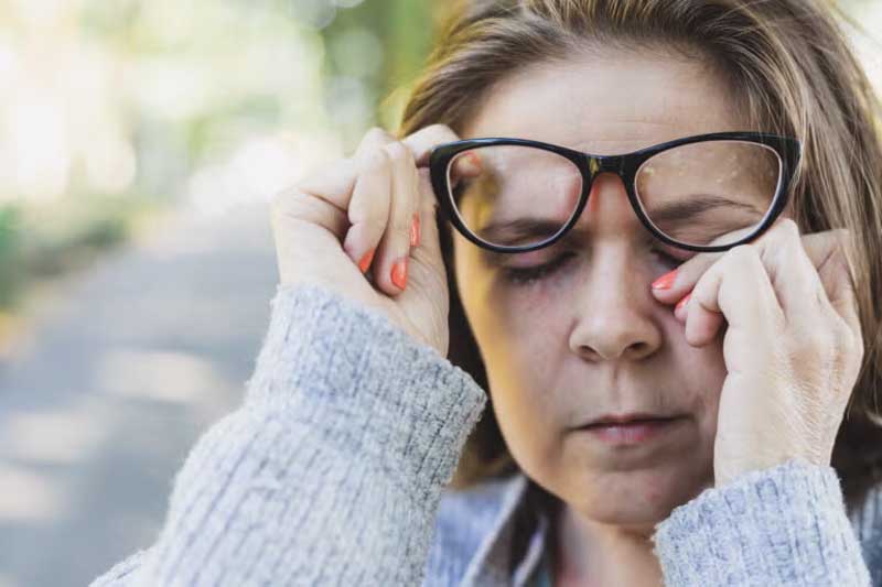 Women rubbing eyes