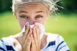 Women sneezing without her specs