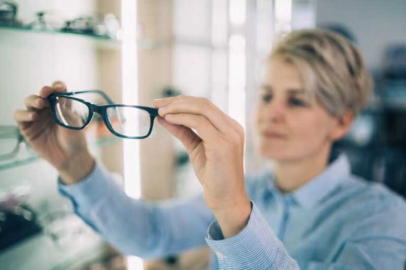 woman holding specs