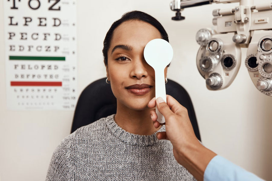 an eye doctor checking a woman's eye