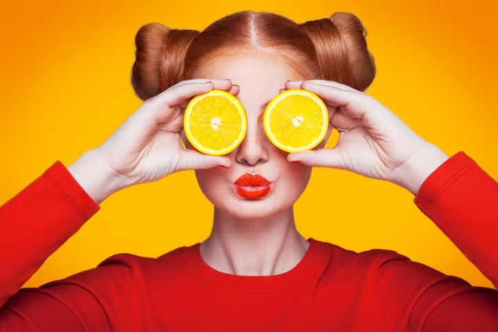 Girl giving a pose with oranges