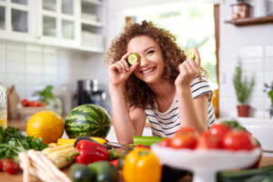Women in kitchen cutting the fruits
