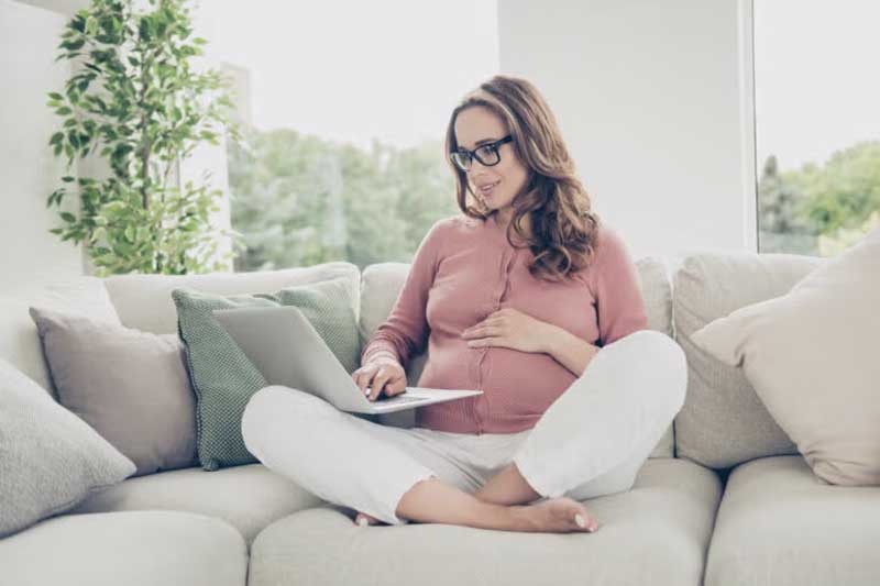 pregnant woman sitting on couch