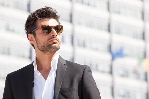 A man wearing a suit and sunglasses
