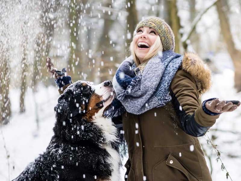woman and dog in snow