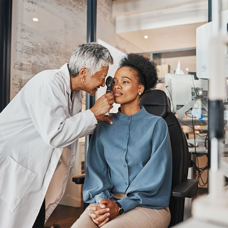 Optometrist performing an eye exam on a patient in Derry, NH, and Nearby Areas