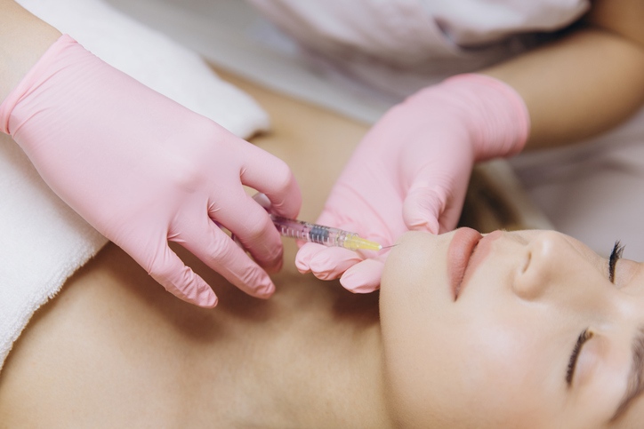 A Person getting lip augmentation injection in Derry & Surrounding Areas, NH