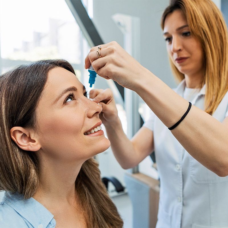 Eye care professional applying lubricating eye drops to a patient in Derry, NH